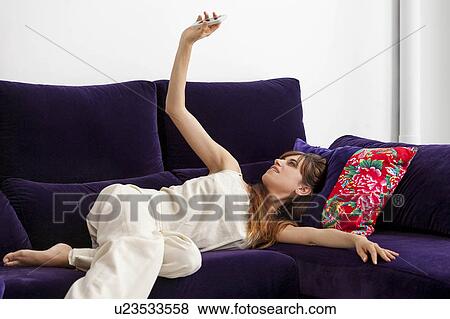 Woman taking picture of herself on sofa View Large Photo Image Stock Photo - Woman taking picture of herself on sofa. Fotosearch