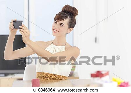 Woman taking picture with cell phone View Large Photo Image Picture - Woman taking picture with cell phone. Fotosearch
