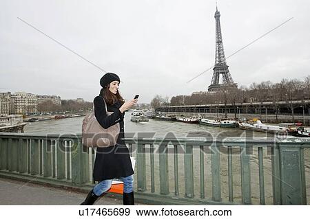 Woman using cell phone on waterfront View Large Photo Image Stock Photo - Woman using cell phone on waterfront. Fotosearch