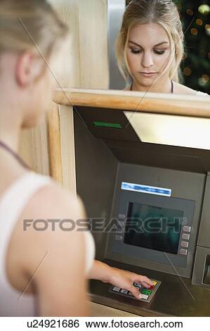 Woman using keypad on ATM View Large Photo Image Stock Photograph - Woman using keypad on ATM. Fotosearch