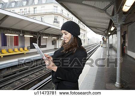 Woman using tablet computer on platform View Large Photo Image Stock Image - Woman using tablet computer on platform. Fotosearch