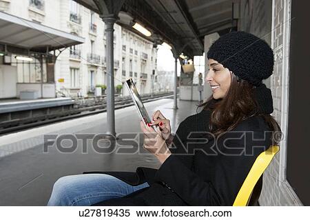 Woman using tablet computer on platform View Large Photo Image Stock Photography - Woman using tablet computer on platform. Fotosearch