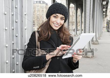 Stock Photo - Woman using tablet computer outdoors. Fotosearch