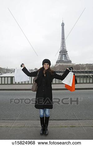 Woman with shopping bags by Eiffel Tower View Large Photo Image Stock Photo - Woman with shopping bags by Eiffel Tower. Fotosearch