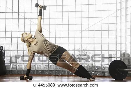 Woman working out in gym View Large Photo Image Stock Photo - Woman working out in gym. Fotosearch