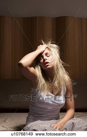 Stock Photo - Woman yawning in bed. Fotosearch