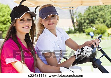 Women driving golf cart on course View Large Photo Image Stock Image - Women driving golf cart on course. Fotosearch