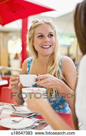 Women having coffee at sidewalk cafe View Large Photo Image Stock Image - Women having coffee at sidewalk cafe. Fotosearch