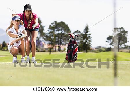 Women playing golf on course View Large Photo Image Stock Image - Women playing golf on course. Fotosearch