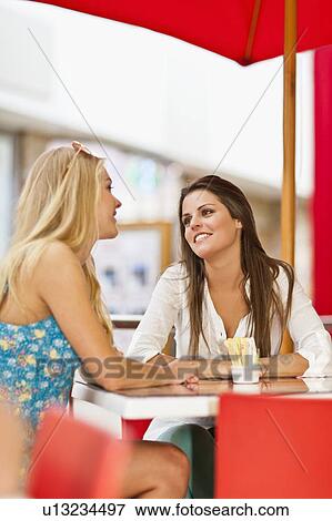 Women talking at sidewalk cafe View Large Photo Image Stock Photo - Women talking at sidewalk cafe. Fotosearch