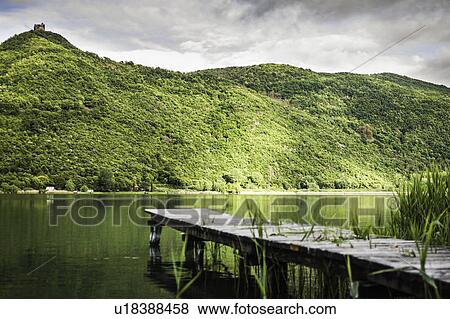 Wooden pier in still rural lake View Large Photo Image Stock Photo - Wooden pier in still rural lake. Fotosearch