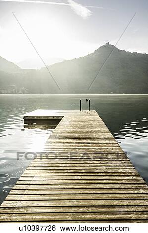 Stock Photograph - Wooden pier in still rural lake. Fotosearch