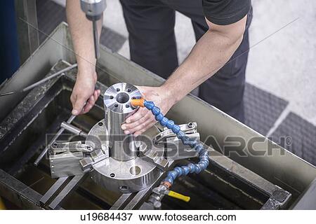 Worker examining steel rod in factory View Large Photo Image Stock Photo - Worker examining steel rod in factory. Fotosearch