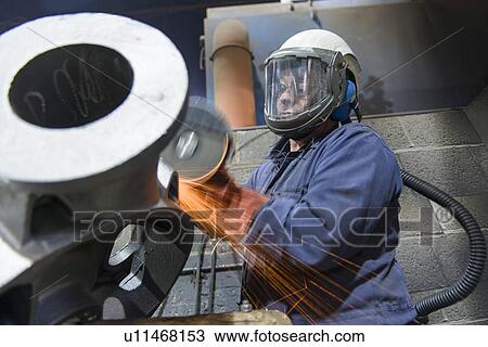 Worker grinding casing in metal foundry View Large Photo Image Stock Image - Worker grinding casing in metal foundry. Fotosearch