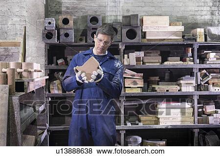 Worker inspecting mould in foundry View Large Photo Image Stock Photo - Worker inspecting mould in foundry. Fotosearch
