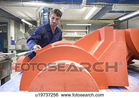 Stock Photograph - Worker making mould in foundry. Fotosearch