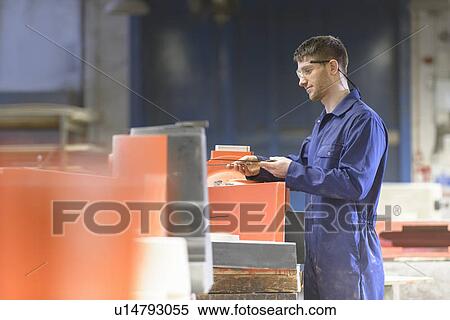 Stock Photography - Worker making mould in foundry. Fotosearch