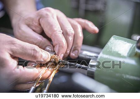 Worker polishing steel parts in factory View Large Photo Image Stock Image - Worker polishing steel parts in factory. Fotosearch