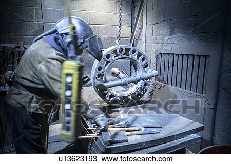 Worker preparing to cut metal in foundry View Large Photo Image Stock Image - Worker preparing to cut metal in foundry. Fotosearch
