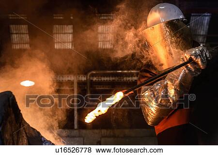 Worker stirring molten metal in country View Large Photo Image Stock Photo - Worker stirring molten metal in country. Fotosearch