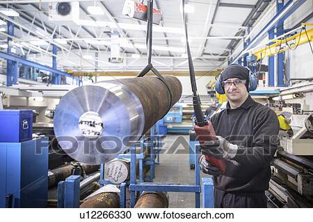 Worker using crane in steel factory View Large Photo Image Stock Image - Worker using crane in steel factory. Fotosearch