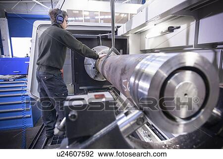 Worker using crane in steel factory View Large Photo Image Stock Image - Worker using crane in steel factory. Fotosearch