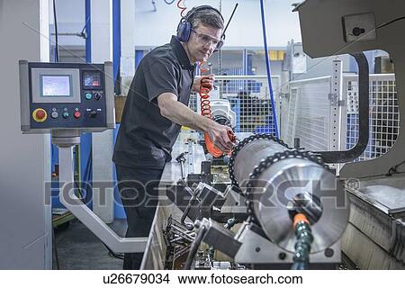 Worker using machinery in factory View Large Photo Image Picture - Worker using machinery in factory. Fotosearch