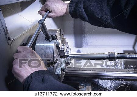 Worker using machinery in factory View Large Photo Image Stock Image - Worker using machinery in factory. Fotosearch