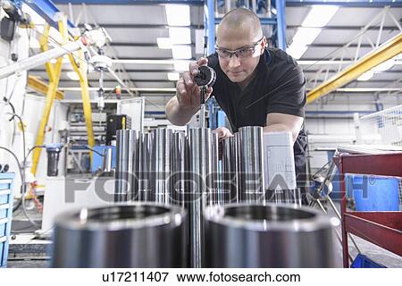 Worker using machinery in factory View Large Photo Image Stock Photo - Worker using machinery in factory. Fotosearch
