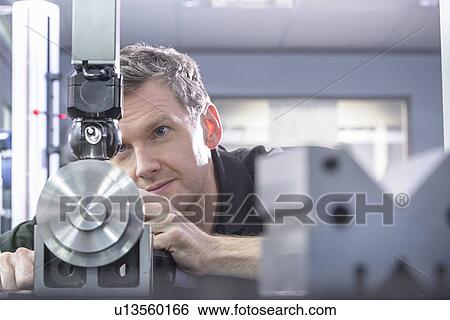 Worker using machinery in factory View Large Photo Image Stock Photograph - Worker using machinery in factory. Fotosearch