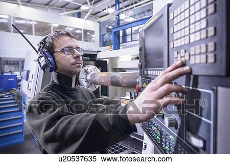 Worker using machinery in steel factory View Large Photo Image Stock Photography - Worker using machinery in steel factory. Fotosearch