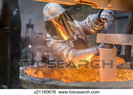 Stock Photograph - Workers cleaning metal flask in factory. Fotosearch