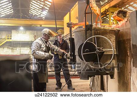 Stock Image - Workers with vat of molten metal. Fotosearch