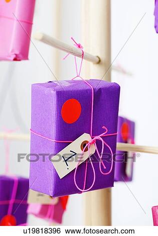 Wrapped gift hanging from hook View Large Photo Image Stock Photograph - Wrapped gift hanging from hook. Fotosearch