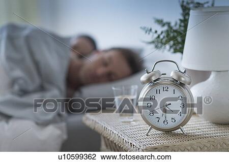 Stock Image - Alarm clock in bedroom. Fotosearch