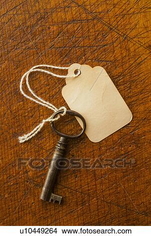 Picture - Antique key with tag. Fotosearch