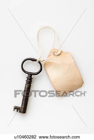 Antique key with tag View Large Photo Image Stock Image - Antique key with tag. Fotosearch