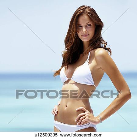 Beach portrait of young woman wearing white bikini View Large Photo Image Stock Photography - Beach portrait of young woman wearing white bikini. Fotosearch
