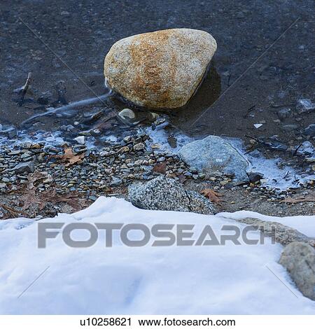 Stock Image - Boulder in water. Fotosearch