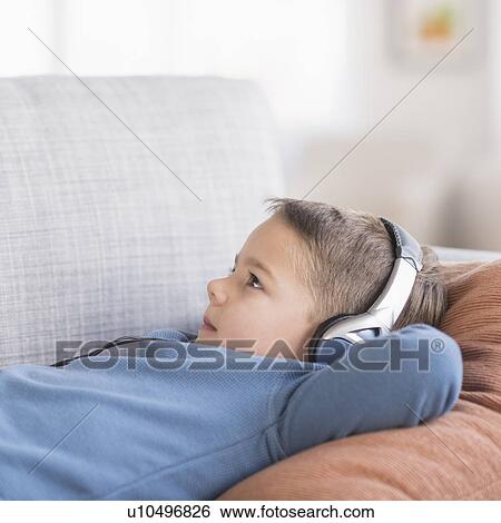 Boy (4-5) listening to music on headphones View Large Photo Image Stock Photograph - Boy (4-5) listening to music on headphones. Fotosearch