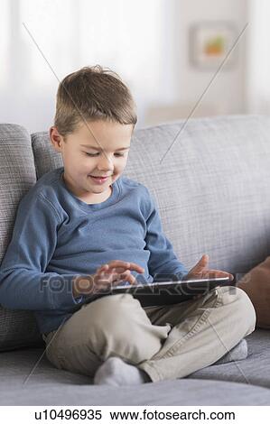 Boy (4-5) using tablet pc View Large Photo Image Stock Photography - Boy (4-5) using tablet pc. Fotosearch