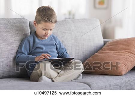 Boy (4-5) using tablet pc View Large Photo Image Stock Photography - Boy (4-5) using tablet pc. Fotosearch