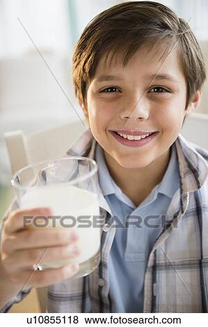 Stock Photo - Boy (8-9) drinking milk. Fotosearch