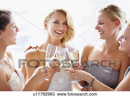 Stock Image - Bride and bridesmaids toasting. Fotosearch