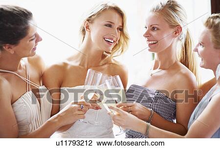 Stock Image - Bride and bridesmaids toasting. Fotosearch