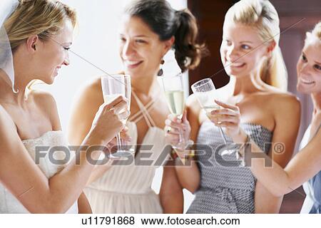 Bride and bridesmaids toasting View Large Photo Image Stock Photo - Bride and bridesmaids toasting. Fotosearch