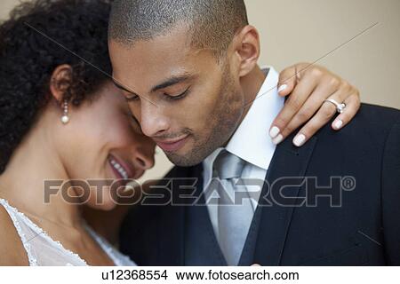 Bride and groom embracing View Large Photo Image Picture - Bride and groom embracing. Fotosearch