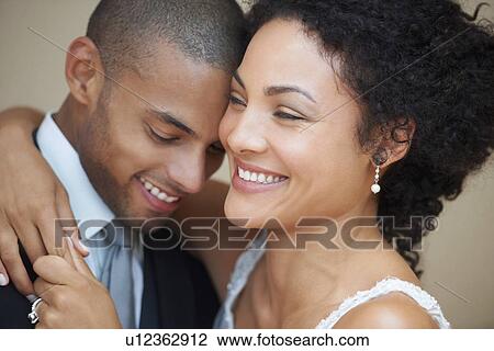 Bride and groom embracing View Large Photo Image Stock Image - Bride and groom embracing. Fotosearch