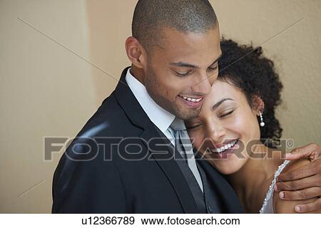 Stock Photo - Bride and groom embracing. Fotosearch