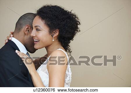 Bride and groom embracing View Large Photo Image Stock Photograph - Bride and groom embracing. Fotosearch